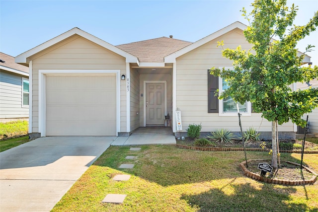 ranch-style house featuring a garage and a front yard