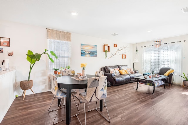 dining area with dark hardwood / wood-style flooring