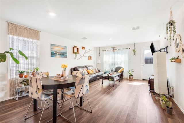 dining space with dark wood-type flooring