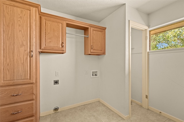 washroom with washer hookup, cabinets, a textured ceiling, and hookup for an electric dryer