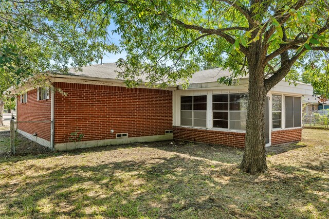 view of side of property with a yard