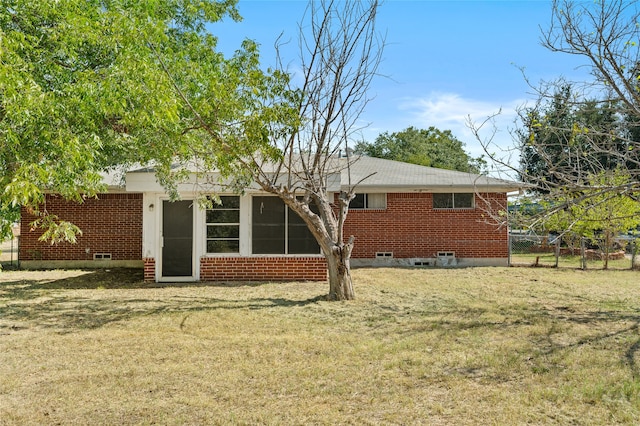 rear view of house with a yard