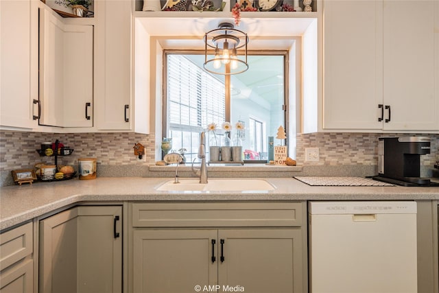 kitchen with dishwasher, decorative backsplash, decorative light fixtures, and sink