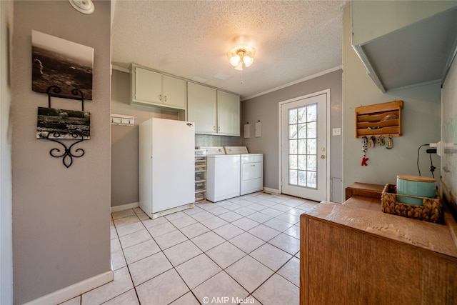 washroom featuring cabinets, washing machine and dryer, light tile patterned floors, and a textured ceiling