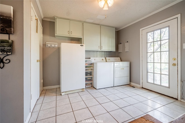 laundry area featuring washer and dryer, cabinets, light tile patterned floors, and a textured ceiling