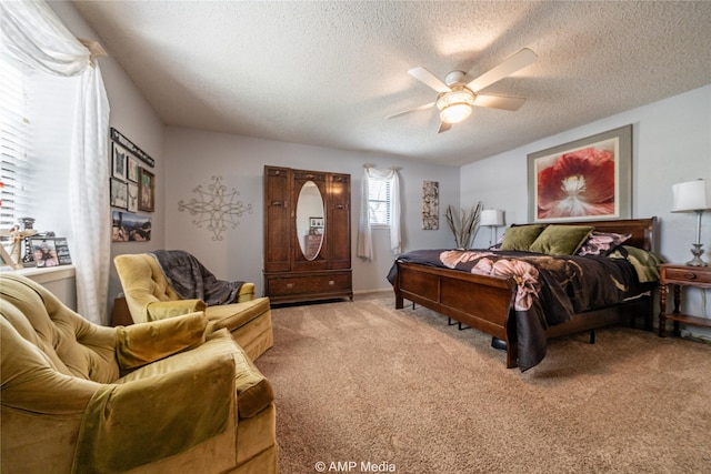 carpeted bedroom with a textured ceiling and ceiling fan