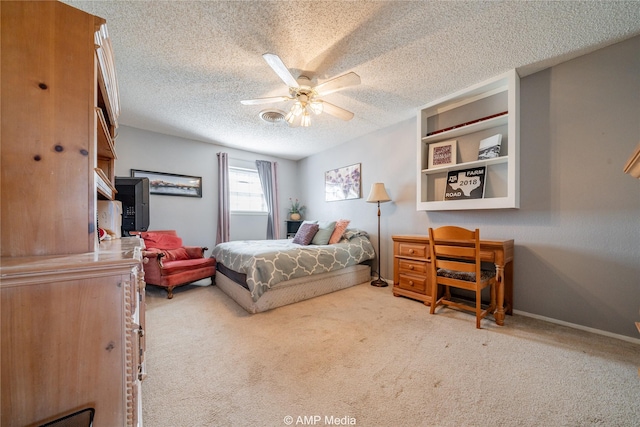 carpeted bedroom featuring a textured ceiling and ceiling fan