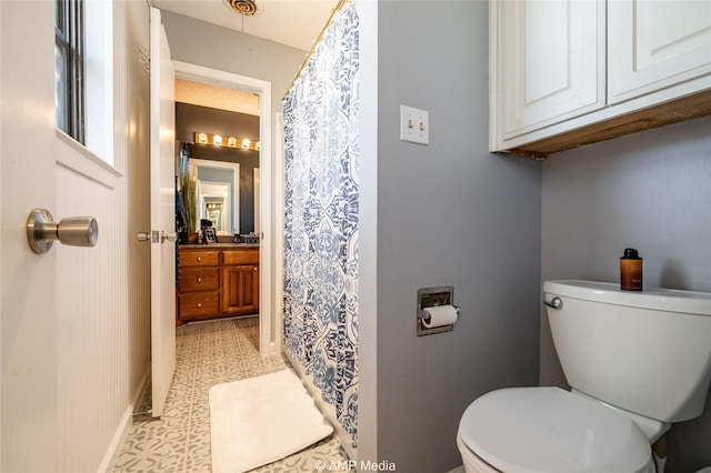 bathroom with tile patterned floors, vanity, and toilet