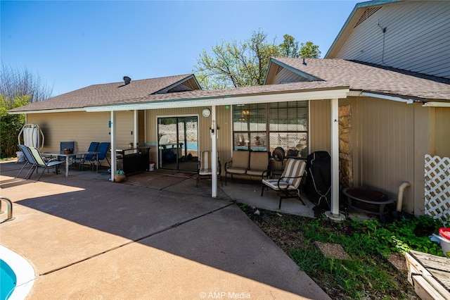 rear view of house with an outdoor living space and a patio area