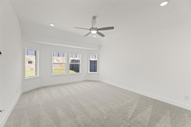 carpeted spare room featuring ceiling fan