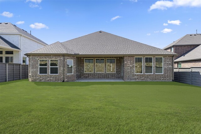 back of property featuring a yard and a patio