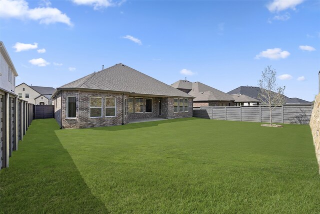 rear view of house with a yard