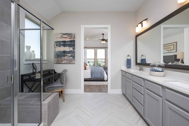 bathroom featuring a shower with door, vaulted ceiling, vanity, and ceiling fan