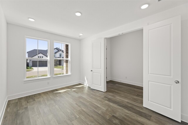 unfurnished room featuring dark hardwood / wood-style floors