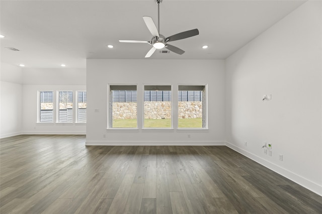 empty room with ceiling fan and dark wood-type flooring