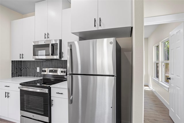 727 W Parnell St, Denison, TX 75020 - kitchen featuring stainless steel appliances, light countertops, tasteful backsplash, and white cabinetry