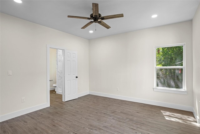 spare room with ceiling fan and dark wood-type flooring