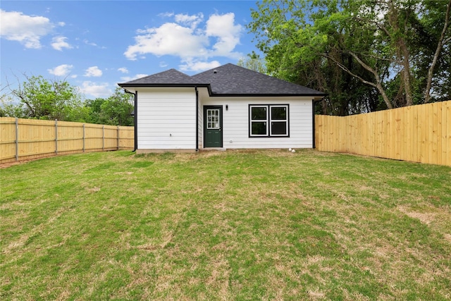 rear view of property with a yard