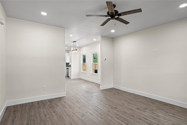 unfurnished living room featuring ceiling fan and hardwood / wood-style floors