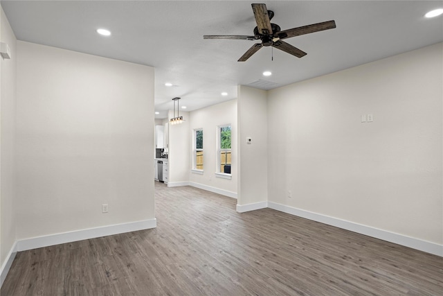 727 W Parnell St, Denison, TX 75020 - unfurnished living room featuring recessed lighting, wood finished floors, baseboards, and ceiling fan
