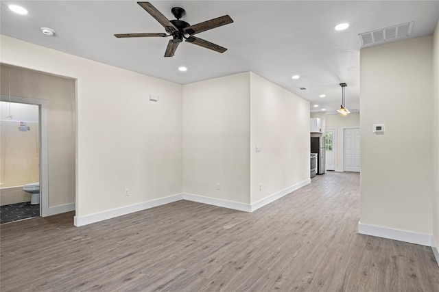 empty room with ceiling fan and wood-type flooring