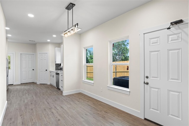 entrance foyer with light hardwood / wood-style floors and sink