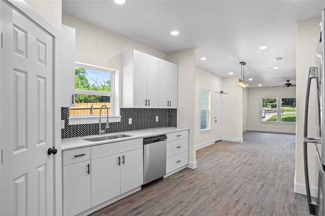 727 W Parnell St, Denison, TX 75020 - kitchen featuring appliances with stainless steel finishes, a sink, light countertops, decorative backsplash, and recessed lighting