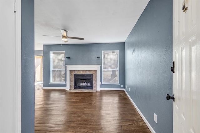 unfurnished living room featuring ceiling fan and wood-type flooring