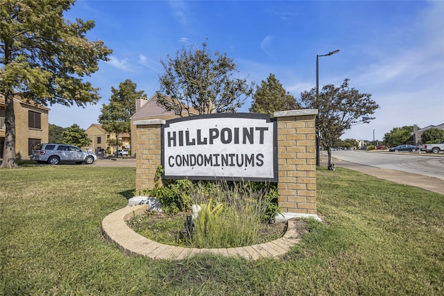 community / neighborhood sign with a lawn