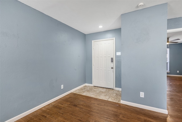 foyer entrance featuring ceiling fan and light wood-type flooring