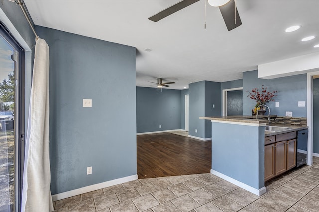 kitchen with ceiling fan, light tile patterned floors, and sink