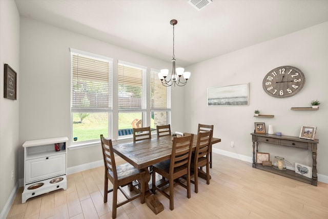 dining area featuring a chandelier and light wood-type flooring