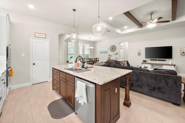 kitchen with ceiling fan with notable chandelier, white cabinetry, stainless steel appliances, light hardwood / wood-style flooring, and a kitchen island with sink