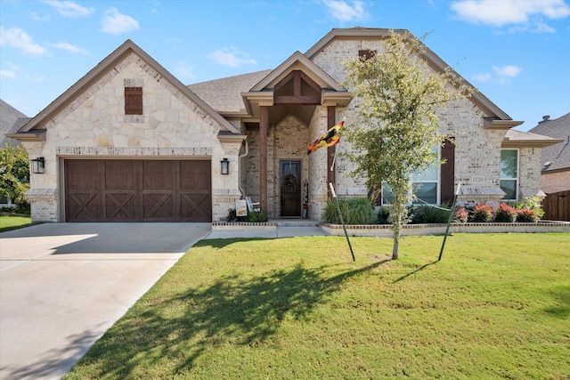 view of front of house with a front yard and a garage