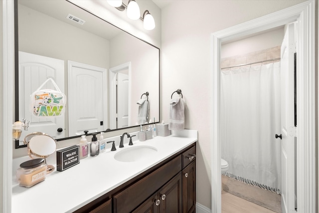 bathroom with vanity, toilet, and a shower with curtain