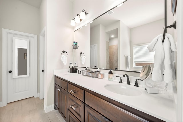 bathroom with vanity, hardwood / wood-style floors, and a shower