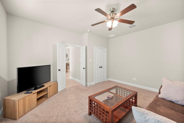 carpeted living room featuring ceiling fan