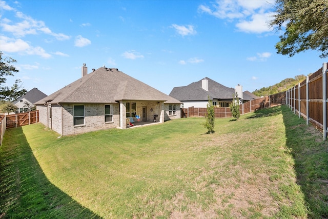 back of property with a patio area and a lawn