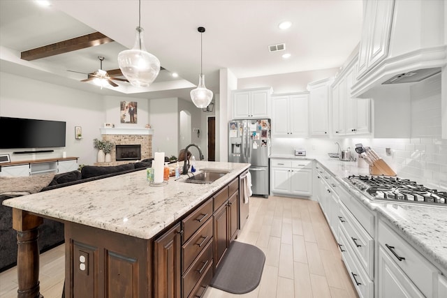 kitchen featuring custom exhaust hood, white cabinets, and sink