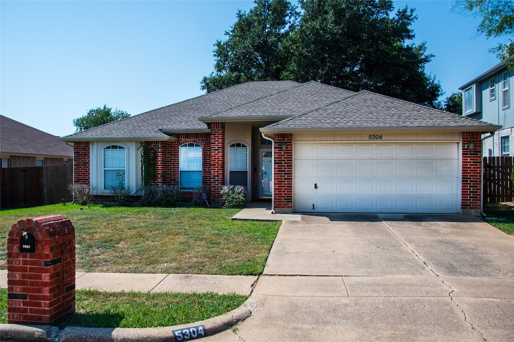 single story home with a garage and a front yard