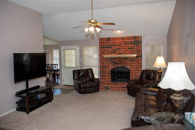 living room featuring lofted ceiling, carpet flooring, ceiling fan, and a brick fireplace