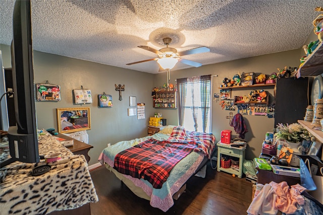 bedroom with dark hardwood / wood-style flooring, a textured ceiling, and ceiling fan