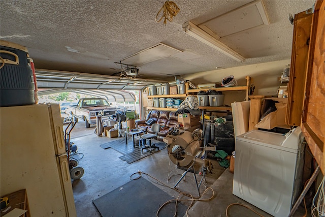 garage with a garage door opener, white refrigerator, and washer / clothes dryer