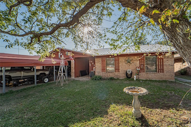 exterior space featuring a carport and a front yard