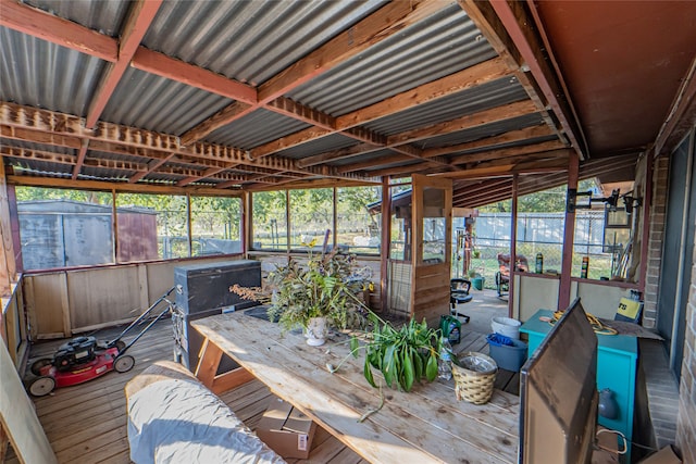 sunroom featuring plenty of natural light and vaulted ceiling