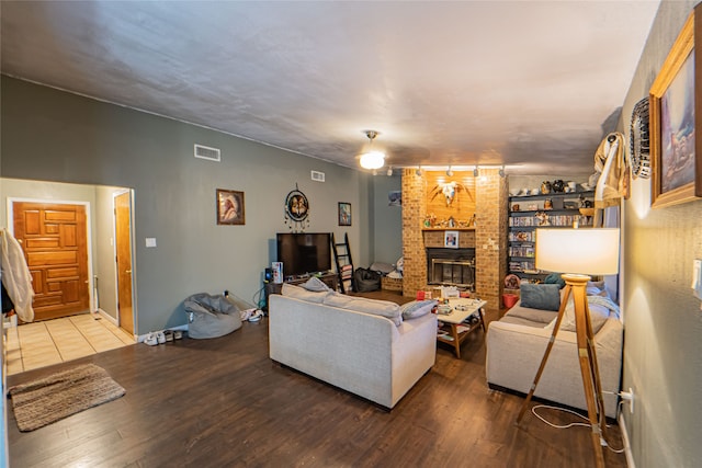 living room featuring a fireplace and wood-type flooring