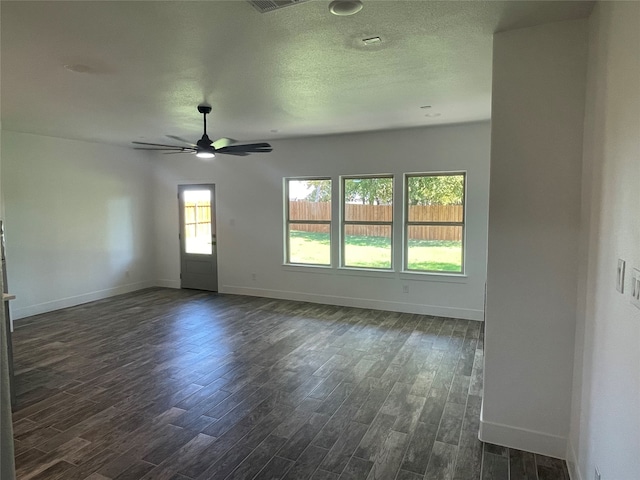 spare room with dark wood-type flooring and ceiling fan