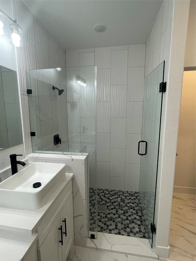 bathroom featuring walk in shower and vanity