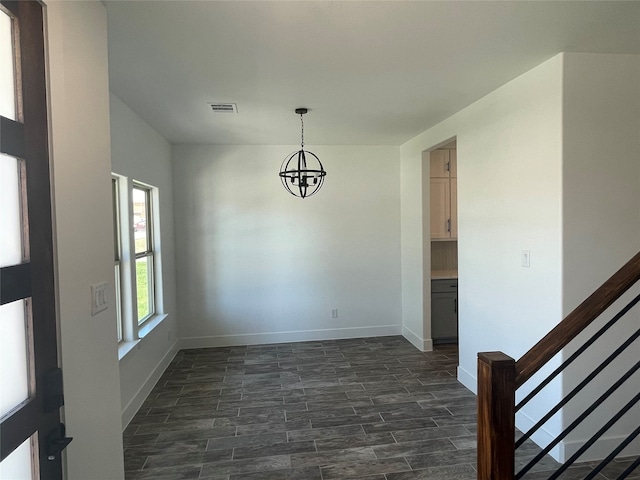 unfurnished dining area with an inviting chandelier and dark hardwood / wood-style flooring