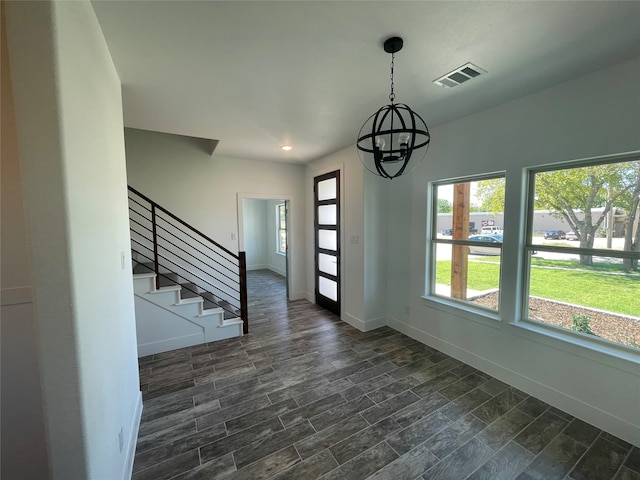 interior space featuring a chandelier and dark wood-type flooring